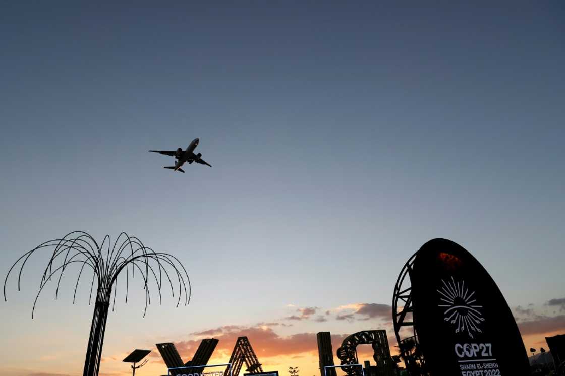 An aeroplane flies above the green zone at the Sharm el-Sheikh International Convention Centre, during the COP27 climate conference