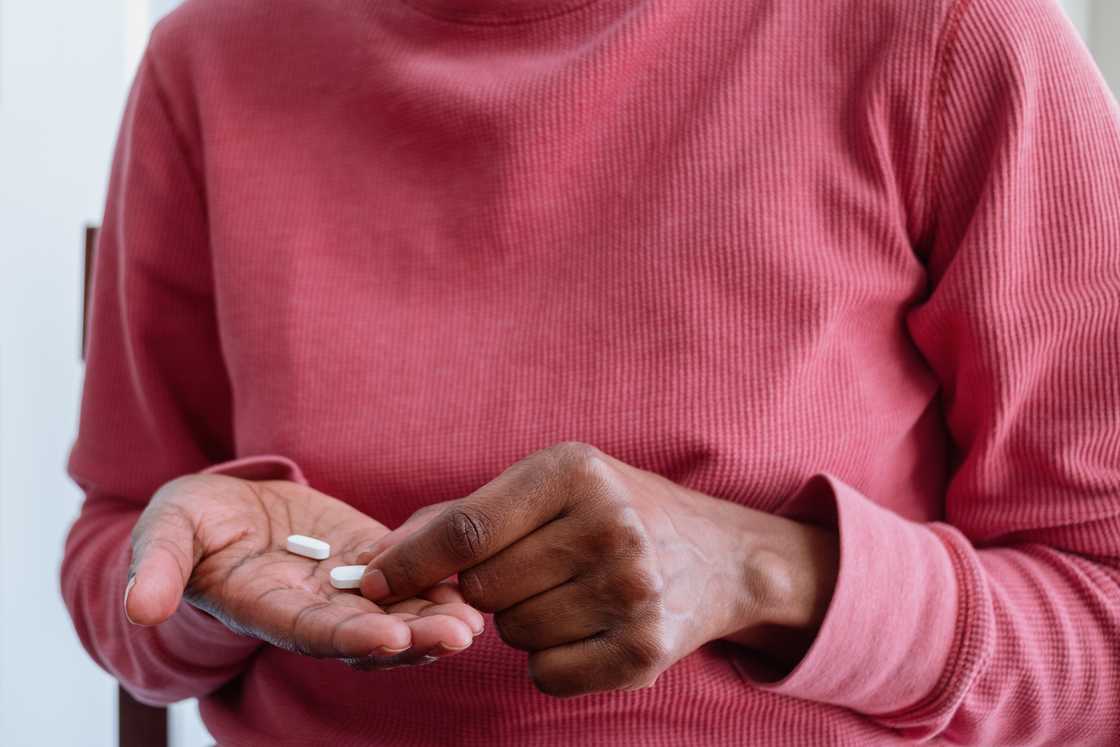 A woman taking pills