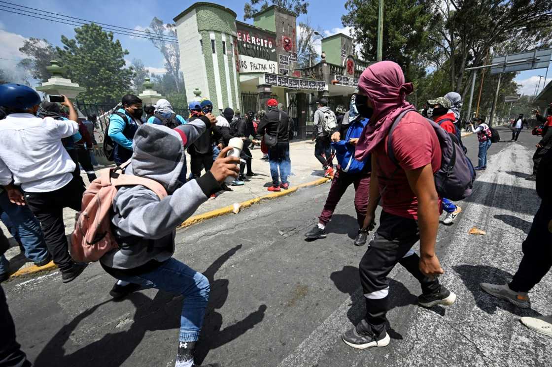 Protesters throw stones and homemade explosive devices at a Mexican military camp during a demonstration over the disappearance of 43 students in 2014 Protesters throw stones and homemade explosive devices at a Mexican military camp during a demonstration over the disappearance of 43 students in 2014