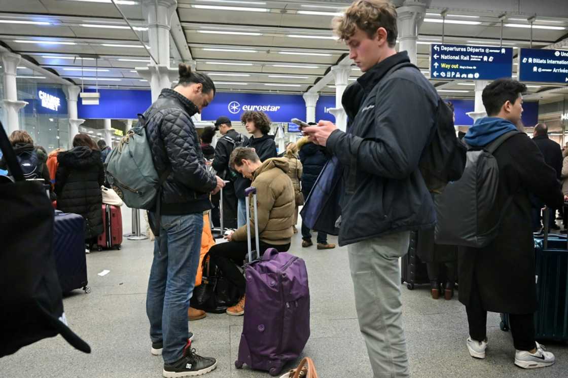 Travellers at St Pancras waited for news Travellers at St Pancras waited for news