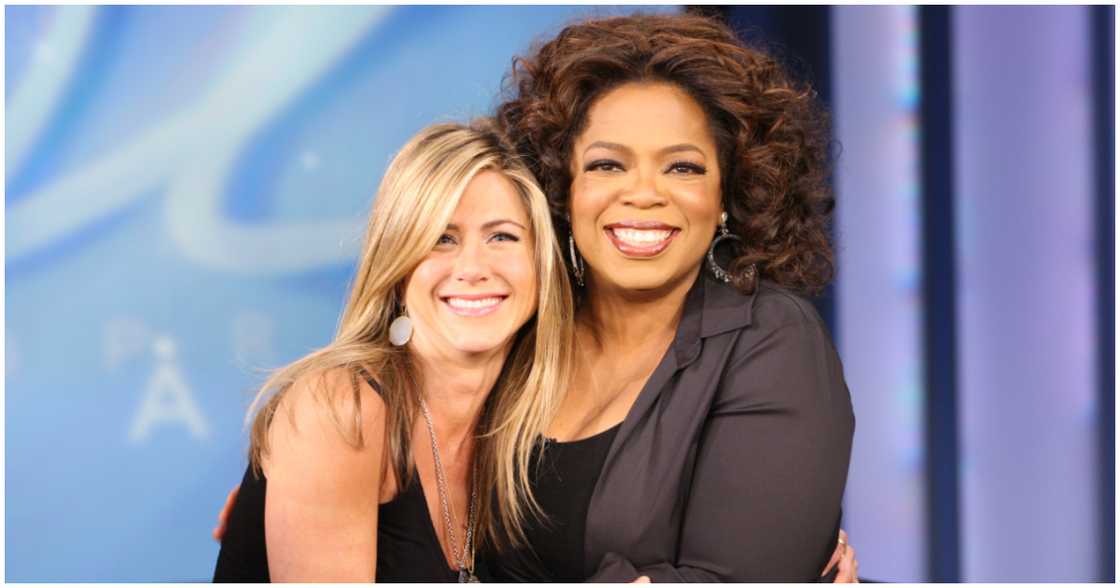 Jennifer Aniston (left) takes a picture with Oprah Winfrey (right) Jennifer Aniston (left) takes a picture with Oprah Winfrey (right)