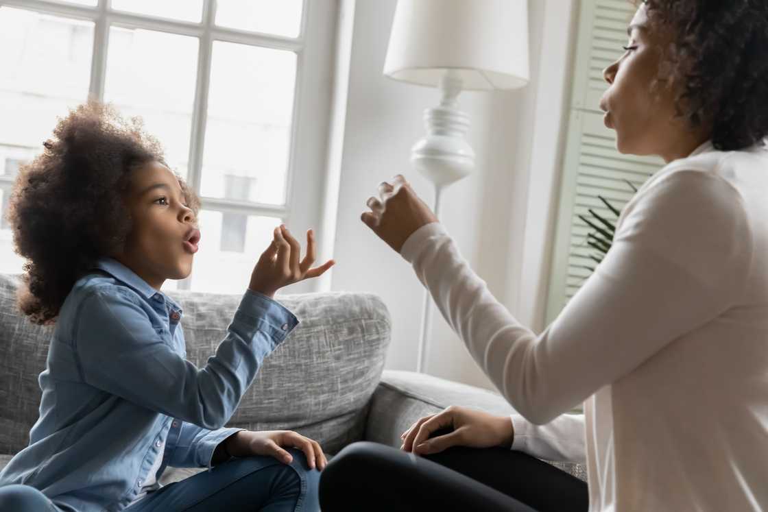 A mother and daughter using sign language A mother and daughter using sign language
