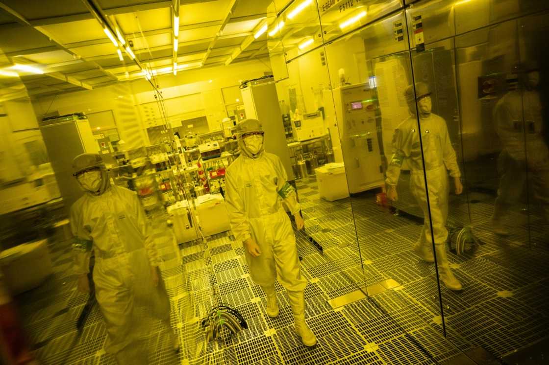 This picture taken on May 1, 2024 shows Tokyo University PhD student Kei Misumi (L) working in a clean room at the University of Tokyo This picture taken on May 1, 2024 shows Tokyo University PhD student Kei Misumi (L) working in a clean room at the University of Tokyo