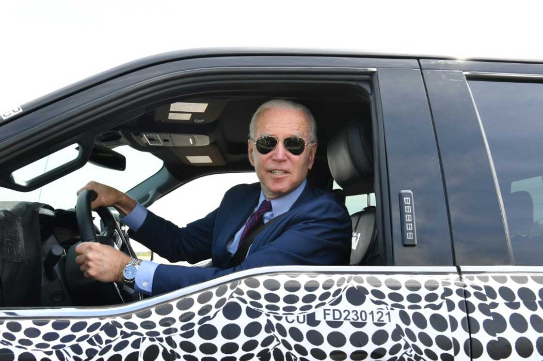 US President Joe Biden, seen here in May driving the new electric Ford F-150 Lightning, will be back in Detroit this week for the first Detroit Auto Show since the pandemic US President Joe Biden, seen here in May driving the new electric Ford F-150 Lightning, will be back in Detroit this week for the first Detroit Auto Show since the pandemic