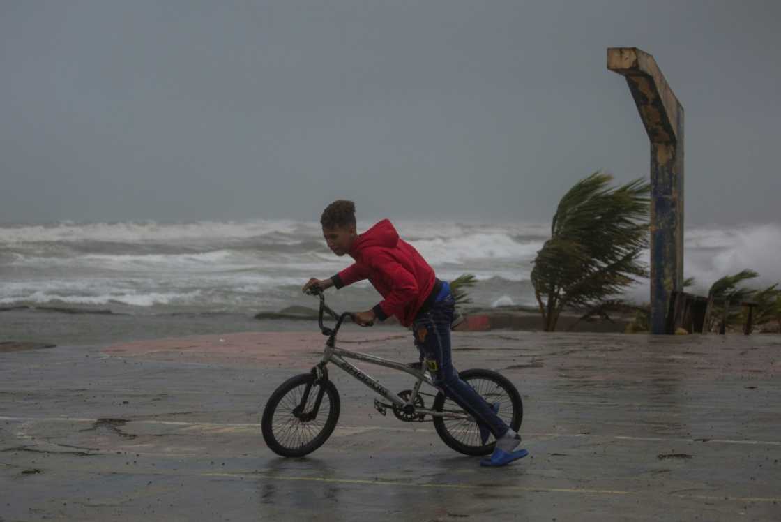 A young person rides his bicycle in Nagua, Dominican Republic, on September 19, 2022 A young person rides his bicycle in Nagua, Dominican Republic, on September 19, 2022