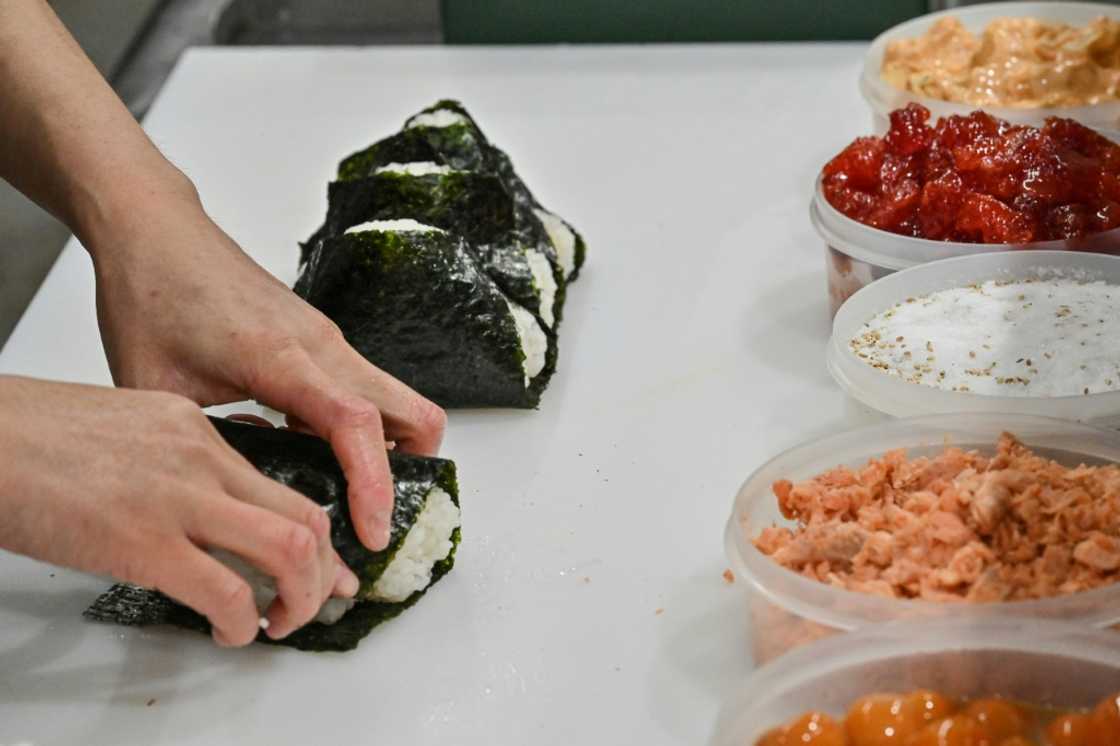 A staff member prepares onigiri at the restaurant Onigiri Bongo in the Otsuka area of Tokyo A staff member prepares onigiri at the restaurant Onigiri Bongo in the Otsuka area of Tokyo