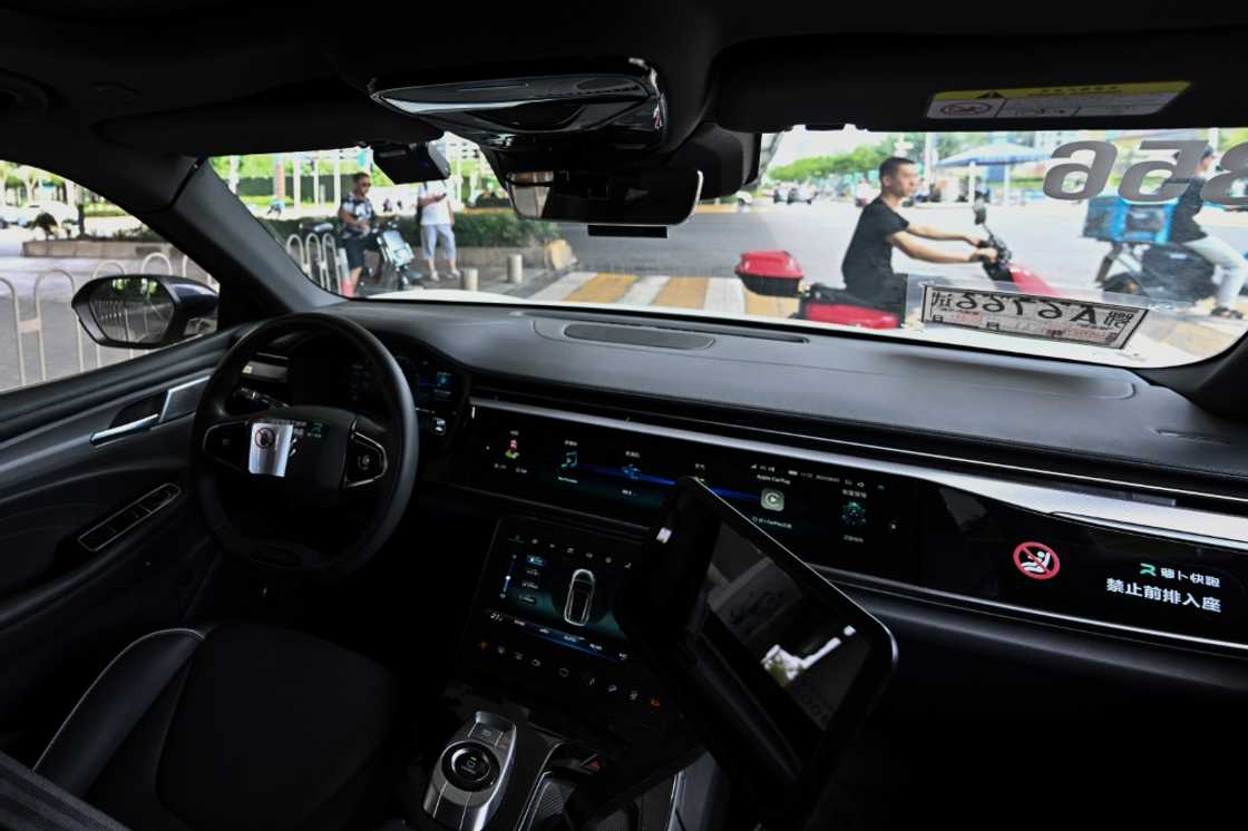 A view from the back seat of a driverless taxi as it navigates through Wuhan, now home to more than 500 so called "robotaxis" A view from the back seat of a driverless taxi as it navigates through Wuhan, now home to more than 500 so called "robotaxis"