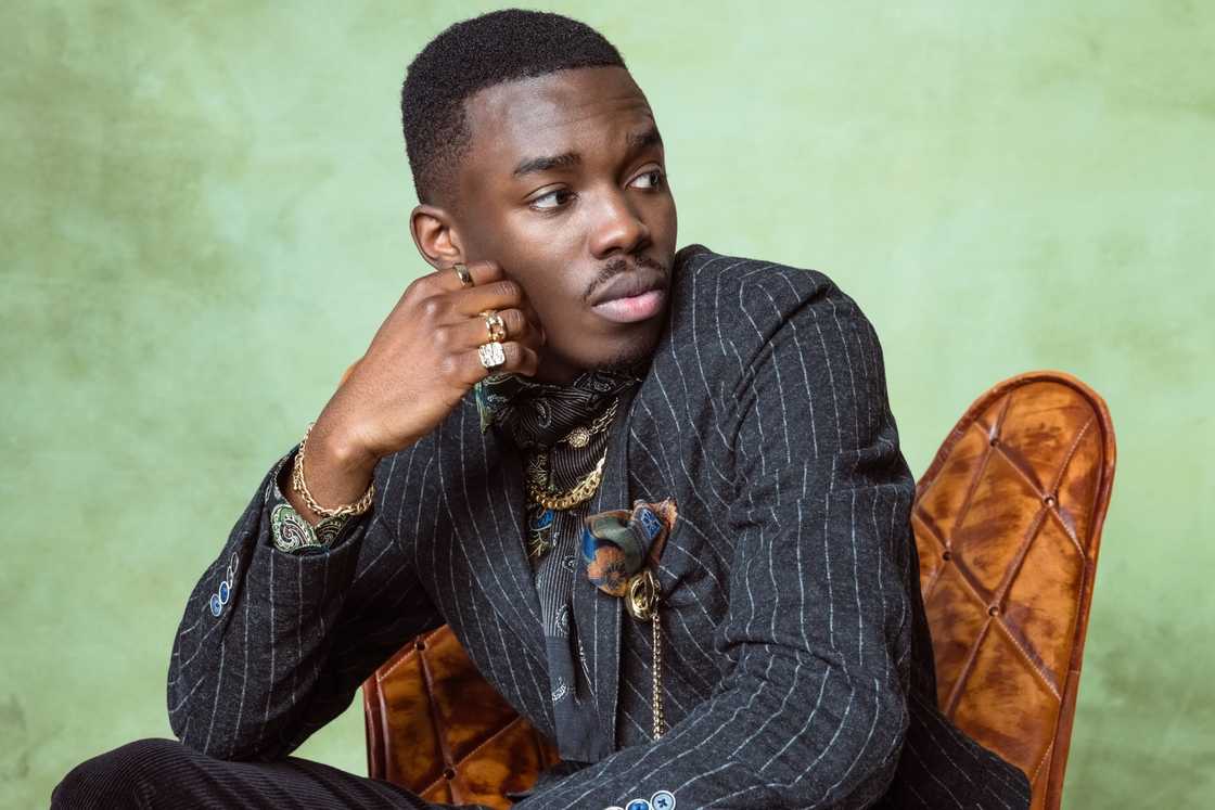 A handsome young man is sitting