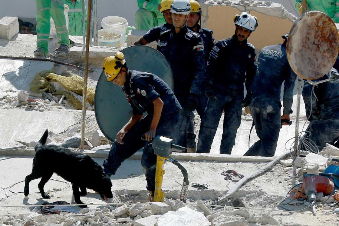 Rescue workers at the disaster site in Jabal al-Weibdeh district, one of Amman's oldest neighbourhoods, known for its vibrant cultural life Rescue workers at the disaster site in Jabal al-Weibdeh district, one of Amman's oldest neighbourhoods, known for its vibrant cultural life
