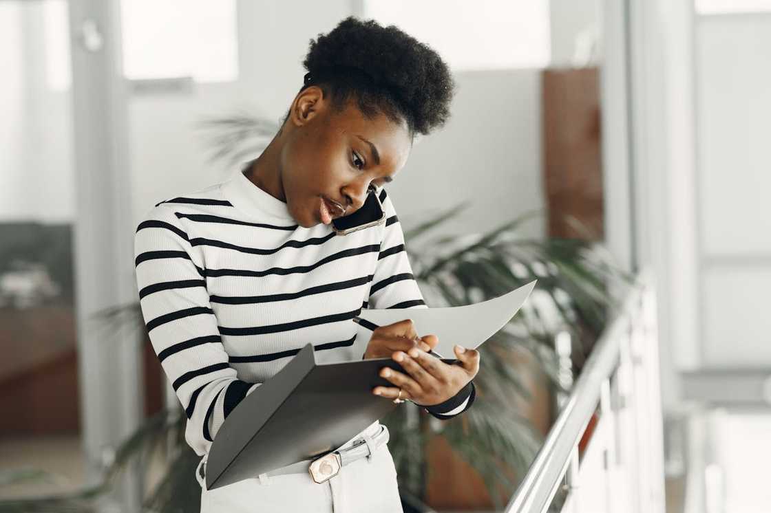 A woman listening intently while on a serious phone call. A woman listening intently while on a serious phone call.