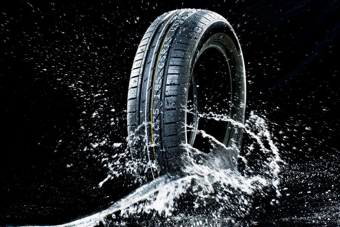 A car tire on a dark background