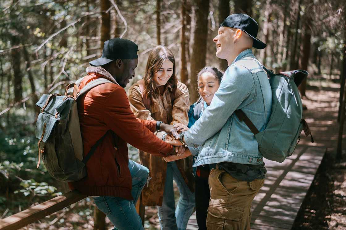 Group of people psyching each other before starting a hike Group of people psyching each other before starting a hike