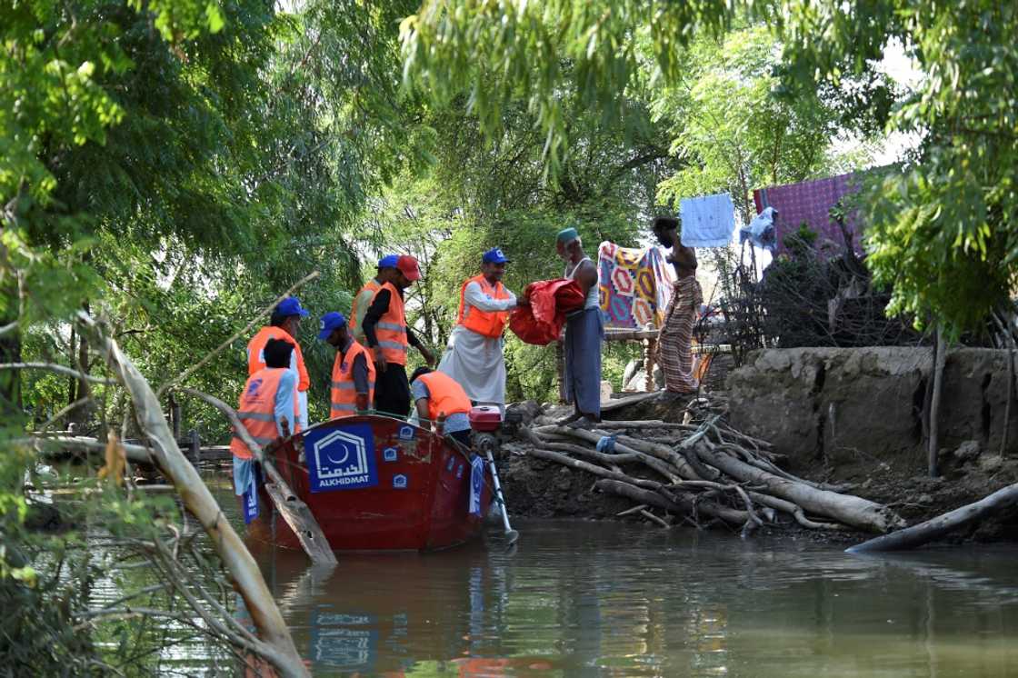 Volunteers from the Al-Khidmat Foundation are using boats to reach isolated villages in the vasted flooded plains of Sindh