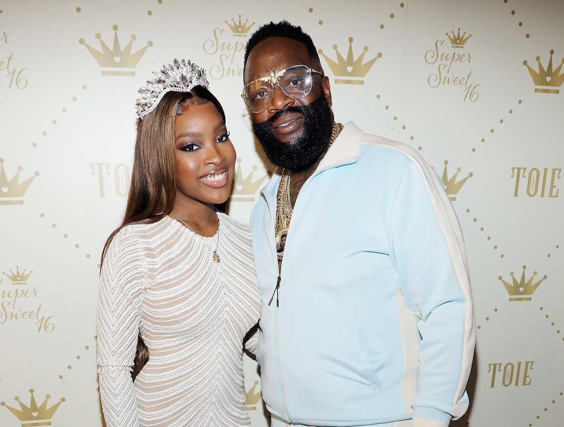 Rick Ross stands beside his daughter Toie Roberts during her 16th birthday in Miami.