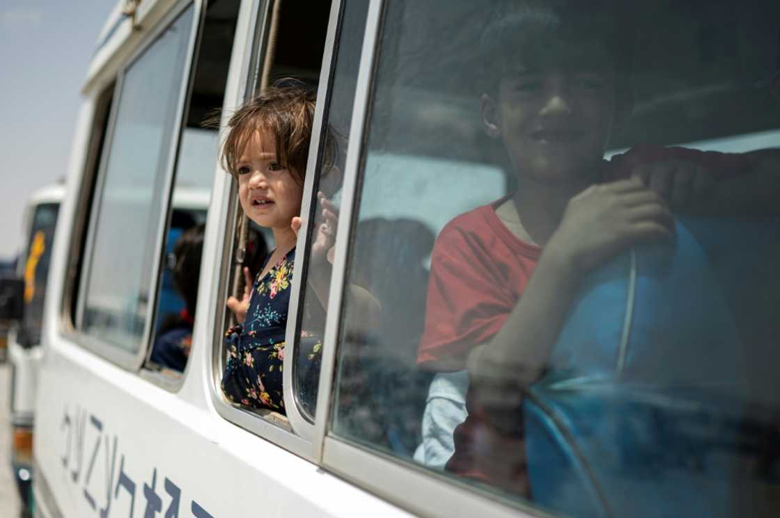 More than 30 buses were chartered to transport men, women and children back to their homes More than 30 buses were chartered to transport men, women and children back to their homes