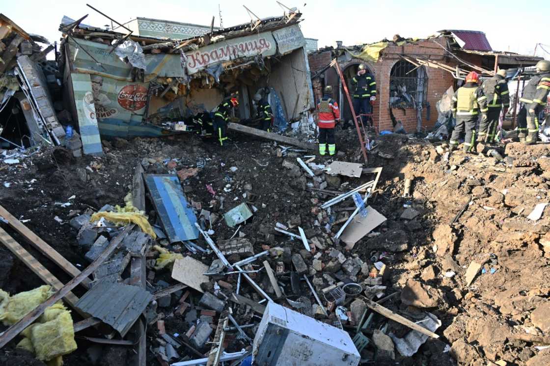 Ukrainian rescuers at the site of a Russian missile strike in Kharkiv Ukrainian rescuers at the site of a Russian missile strike in Kharkiv