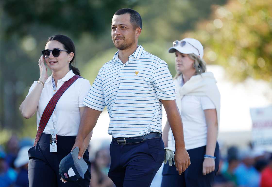 Xander Schauffele walks off the 16th green with Maya Lowe during Friday four-ball matches Xander Schauffele walks off the 16th green with Maya Lowe during Friday four-ball matches