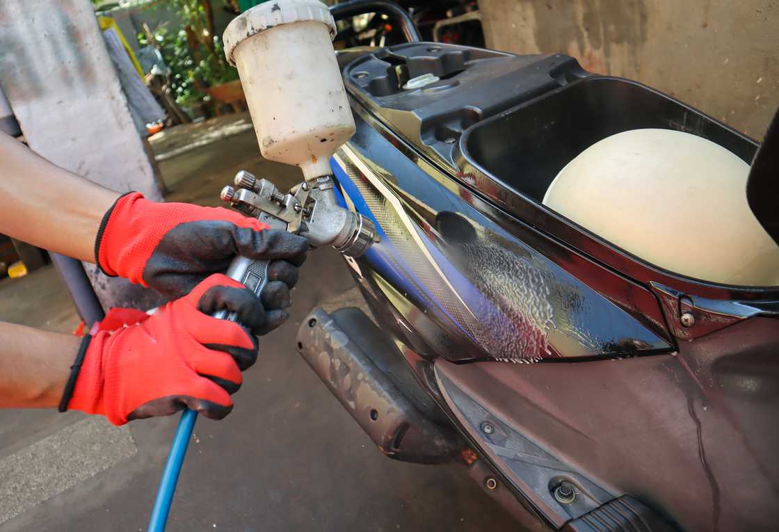 A man painting a bike A man painting a bike