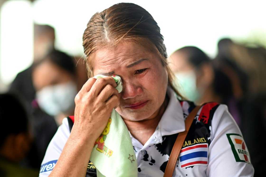 Families gather outside a Thai nursery where an ex-policeman murdered nearly two dozen young children Families gather outside a Thai nursery where an ex-policeman murdered nearly two dozen young children