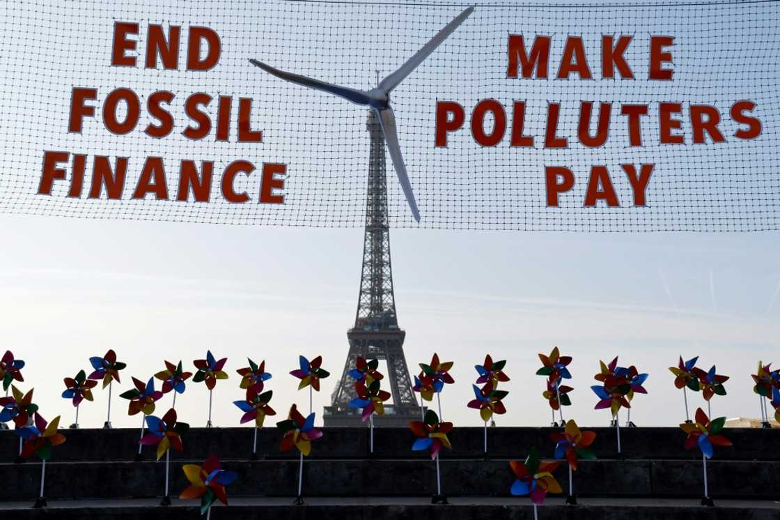 Activists demonstrated against fossil fuel finance in central Paris on the eve of the summit Activists demonstrated against fossil fuel finance in central Paris on the eve of the summit