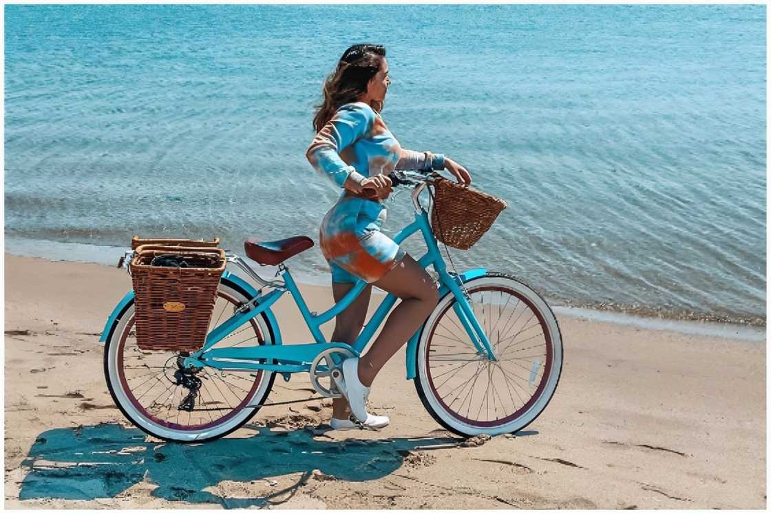 A woman with her bike baskets attached to her bicycle