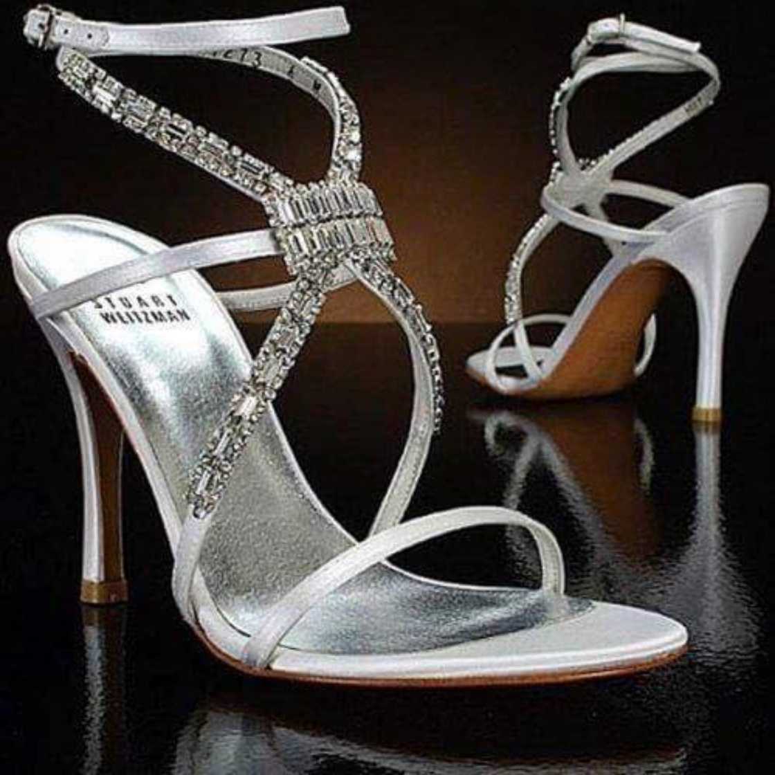 Stuart Weitzman Platinum Guild heels are on a dark background