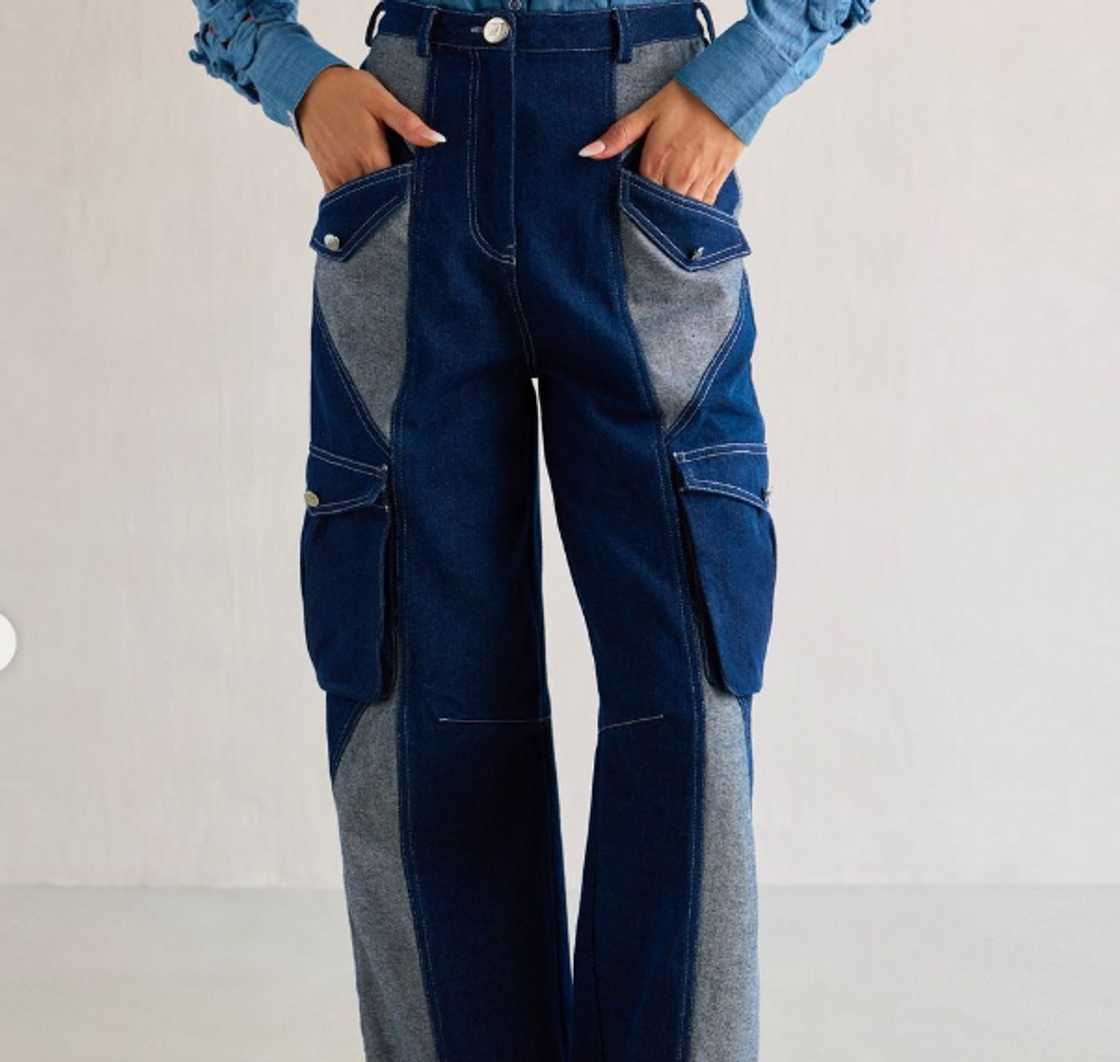 A woman wearing a pair of dual denim cargo pants A woman wearing a pair of dual denim cargo pants