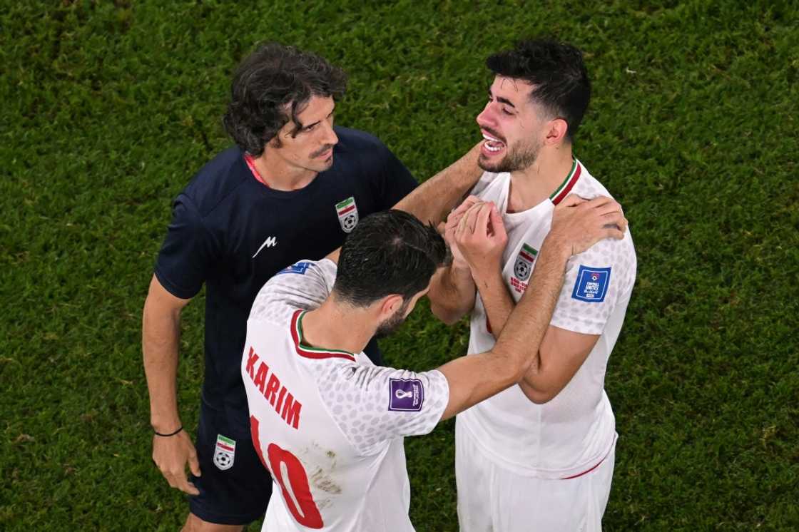 Iran's forward #10 Karim Ansarifard and Iran's midfielder #06 Saeid Ezatolahi cry after the narrow loss to the US Iran's forward #10 Karim Ansarifard and Iran's midfielder #06 Saeid Ezatolahi cry after the narrow loss to the US