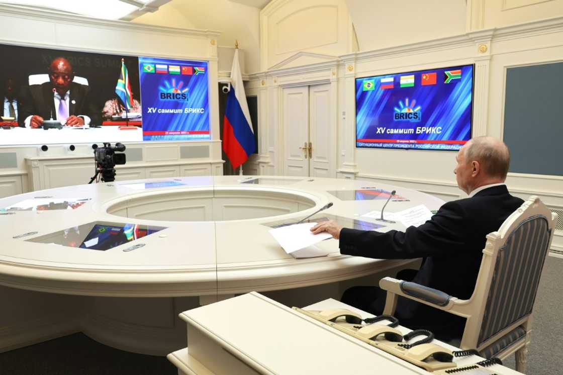 Putin, seen here in a picture distributed by the Russian news agency Sputnik, joined the summit by video link