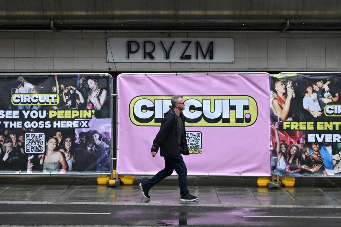 A man walks past the boarded up entrance to the closed-down PRYZM club in Kingston, west London