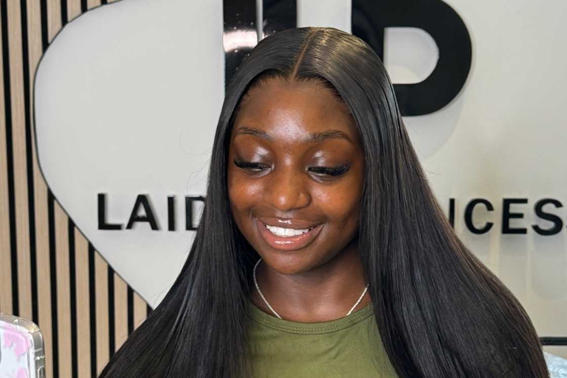 A woman is rocking a long black wig