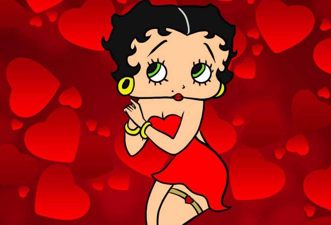 Betty Boop is standing against a red background decorated with love hearts