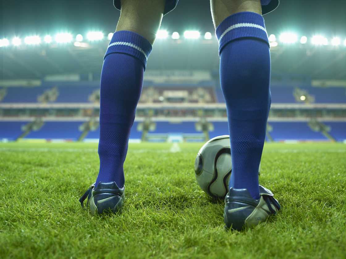 A person in the field sports a pair of blue athletic socks