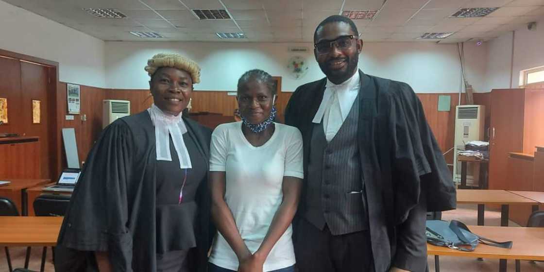 Titilayo Benson flanked by two lawyers