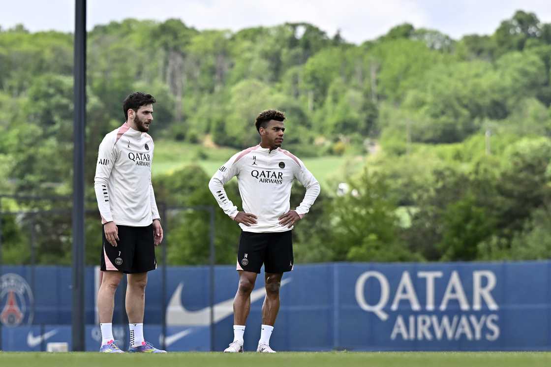 Khvicha Kvaratskhelia and Desire Doue look on during a Paris Saint-Germain training session at Campus PSG on May 05, 2025 in Paris, France Khvicha Kvaratskhelia and Desire Doue look on during a Paris Saint-Germain training session at Campus PSG on May 05, 2025 in Paris, France