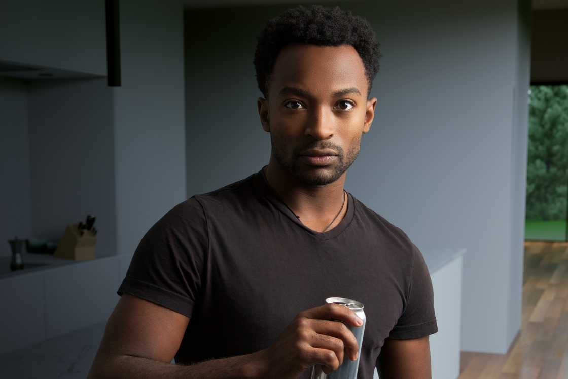 A man is holding a can