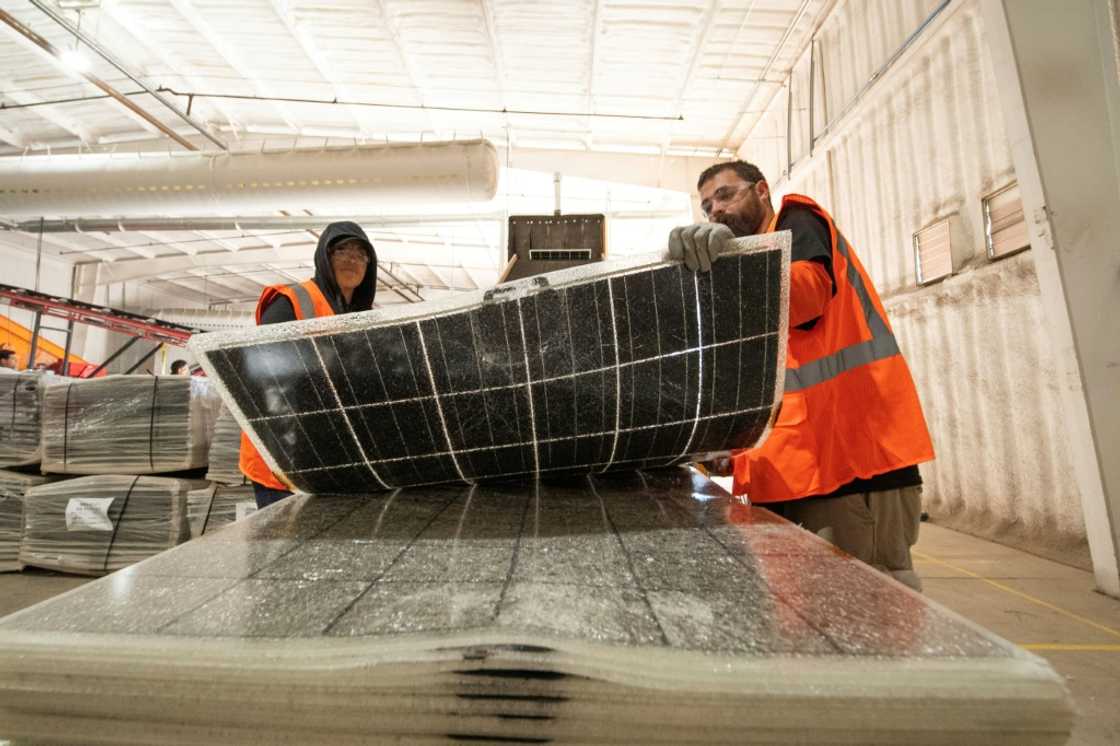 Workers push damaged solar panels into a machine to be recycled at the We Recycle Solar plant in Yuma, Arizona Workers push damaged solar panels into a machine to be recycled at the We Recycle Solar plant in Yuma, Arizona