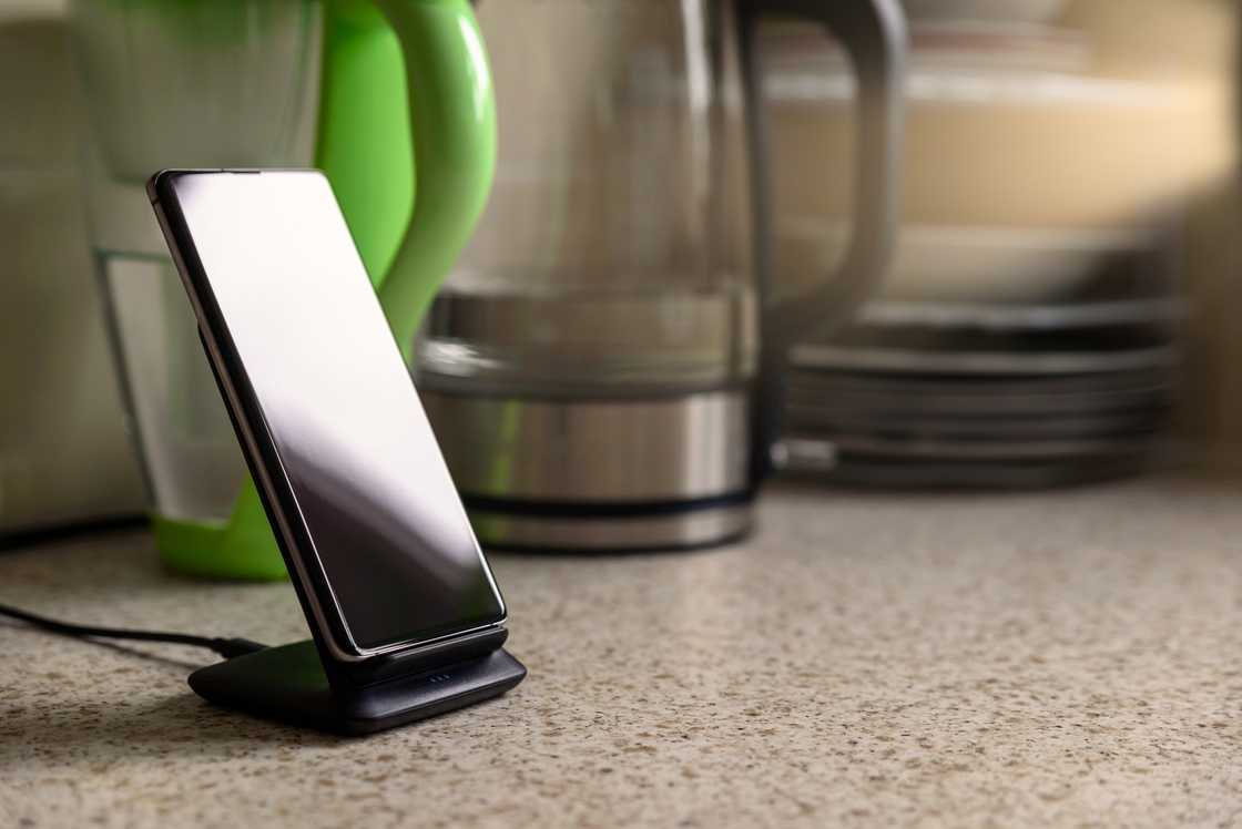 A phone on the kitchen counter A phone on the kitchen counter