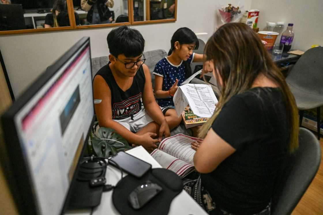 'Virtual assistant' Lyann Lubrico helping her children with their school work at her home in Quezon City 'Virtual assistant' Lyann Lubrico helping her children with their school work at her home in Quezon City