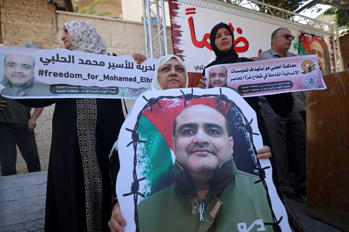 Mohammed Halabi, former Gaza director of World Vision, was sentenced to 12 years in jail on Tuesday for sending cash to Hamas: in this June 2022 photograph his mother holds his portrait in a rally demanding his release Mohammed Halabi, former Gaza director of World Vision, was sentenced to 12 years in jail on Tuesday for sending cash to Hamas: in this June 2022 photograph his mother holds his portrait in a rally demanding his release
