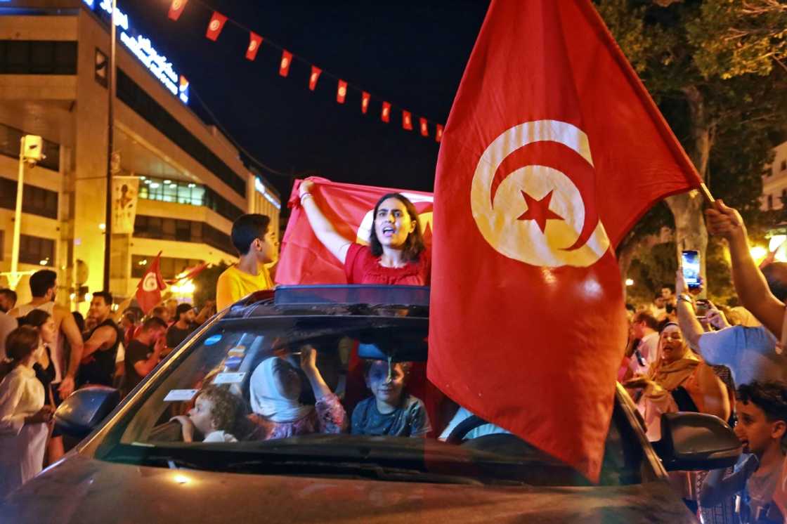 Supporters of Tunisia's President Kais Saied rejoice on Habib Bourguiba Avenue in the capital Tunis after the projected outcome of a constitutional referendum was announced Supporters of Tunisia's President Kais Saied rejoice on Habib Bourguiba Avenue in the capital Tunis after the projected outcome of a constitutional referendum was announced