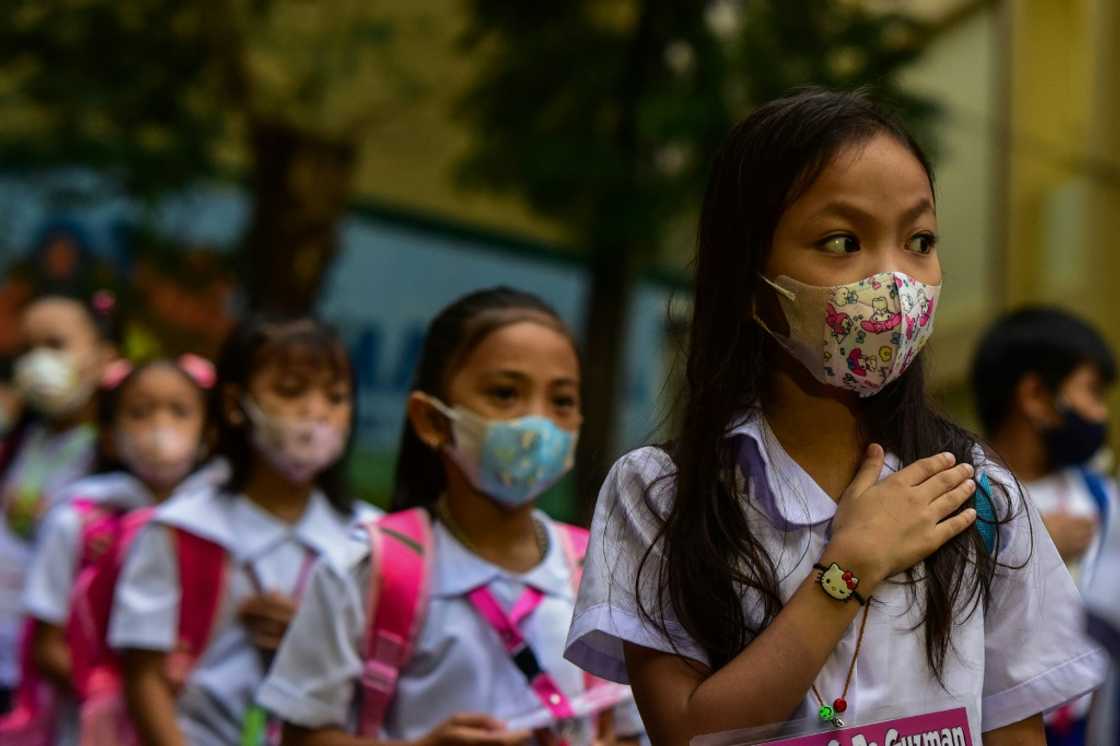 Students attend a flag-raising ceremony at Pedro Guevara Elementary School in Manila on the first day of in-person classes after years-long Covid-19 lockdowns Students attend a flag-raising ceremony at Pedro Guevara Elementary School in Manila on the first day of in-person classes after years-long Covid-19 lockdowns