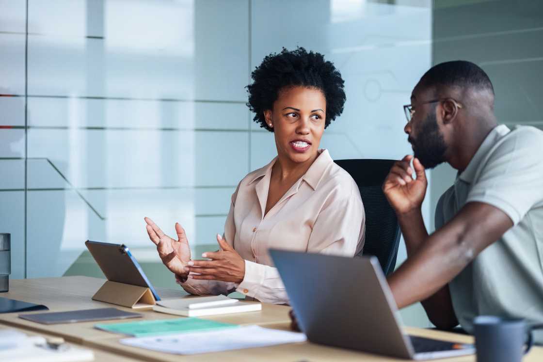 Two young professionals collaborating on case studies.