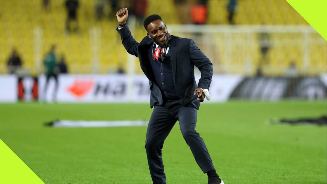 Jay Jay Okocha gestures to the Fenerbahce fans