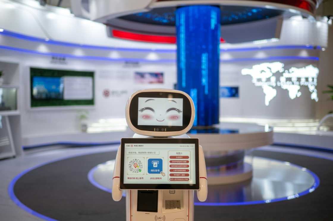A robot greets visitors at a bank in the Asian Games media centre A robot greets visitors at a bank in the Asian Games media centre