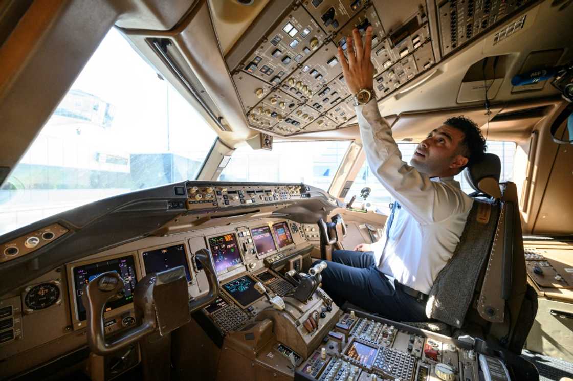Pilot Omar Morsi checks controls in the cockpit of a United Airlines Boeing 777 aircraft at Newark Liberty International Airport in Newark, New Jersey Pilot Omar Morsi checks controls in the cockpit of a United Airlines Boeing 777 aircraft at Newark Liberty International Airport in Newark, New Jersey
