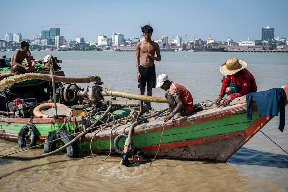 The job is risky; divers spend hours underwater breathing through a hose attached to a pump on the boat above