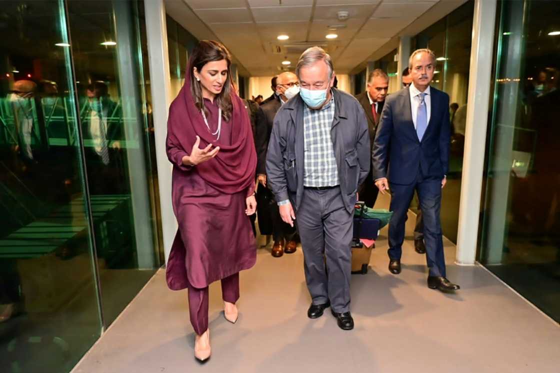 UN Secretary-General Antonio Guterres is briefed by Pakistan's Minister of State for Foreign Affairs Hina Rabbani Khar on arrival at Islamabad Airport in a handout picture from Pakistan authorities