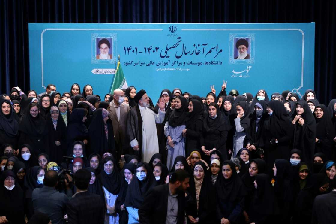 Iran's ultraconservative President Ebrahim Raisi poses for a group photograph with female students at Tehran's Al-Zahra university at the start of the new academic year Iran's ultraconservative President Ebrahim Raisi poses for a group photograph with female students at Tehran's Al-Zahra university at the start of the new academic year