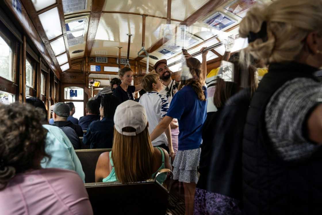Tourists take selfies inside a tram in Lisbon Tourists take selfies inside a tram in Lisbon